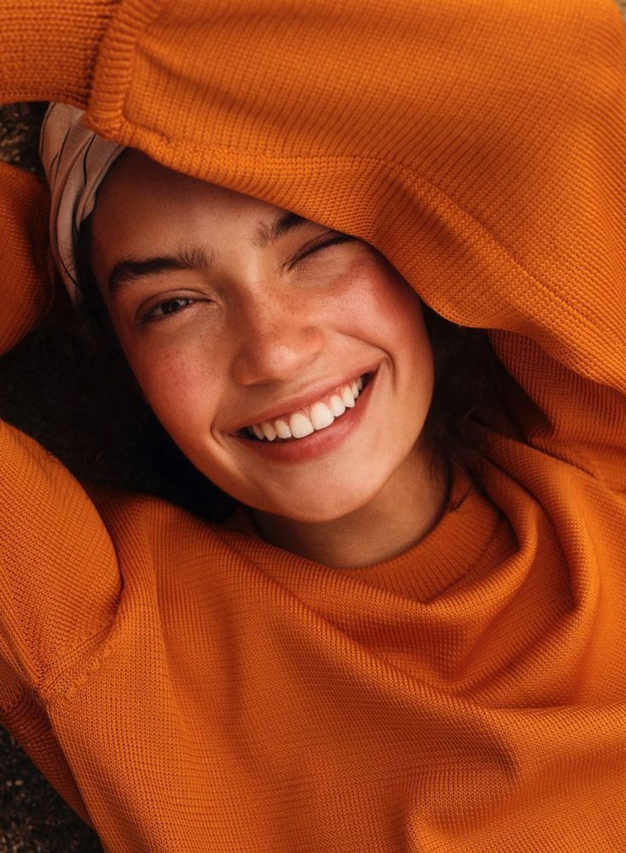 Woman in orange sweater